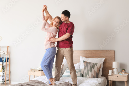 Happy dancing couple in bed...