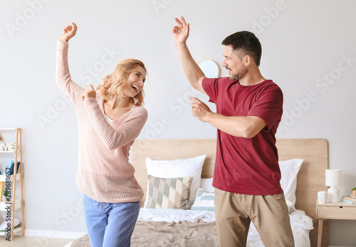 Happy dancing couple in bed...