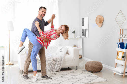 Happy dancing couple at home