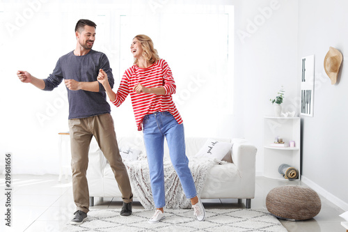 Happy dancing couple at home