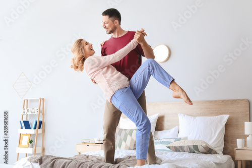 Happy dancing couple in bed...