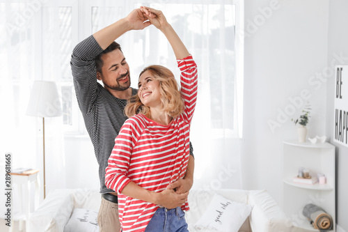 Happy dancing couple at home