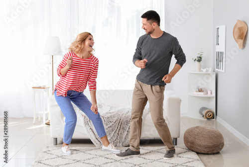 Happy dancing couple at home