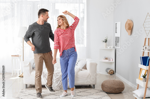Happy dancing couple at home