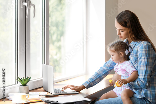 Working mother with her dau...