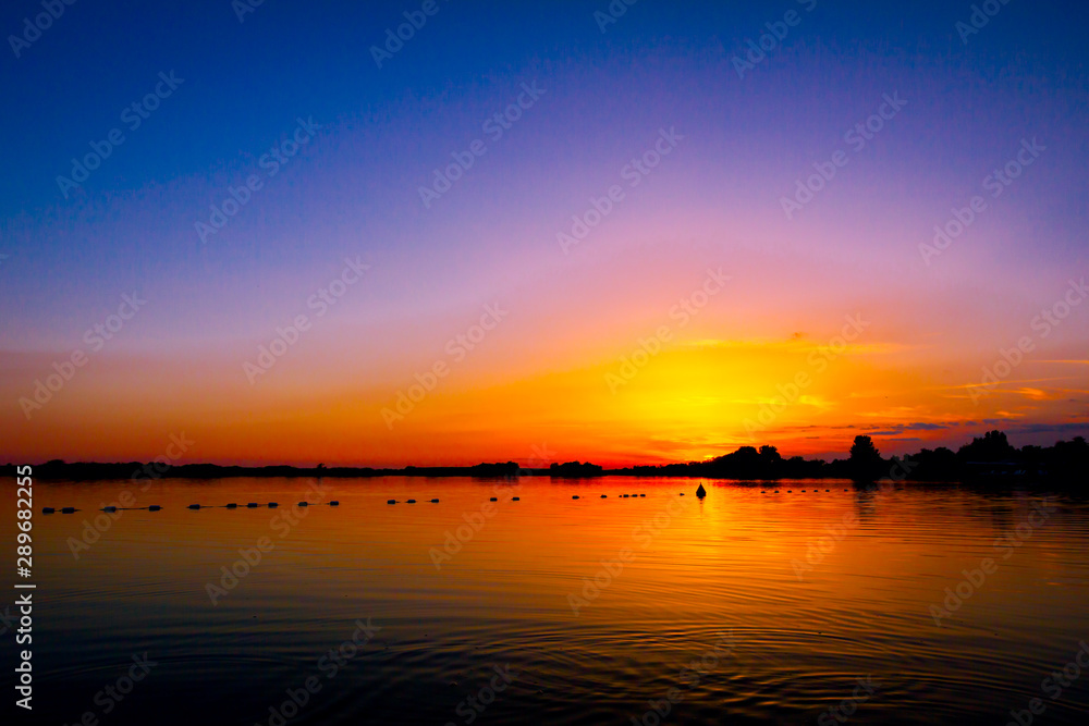 Colorful sky in sunset over the lake