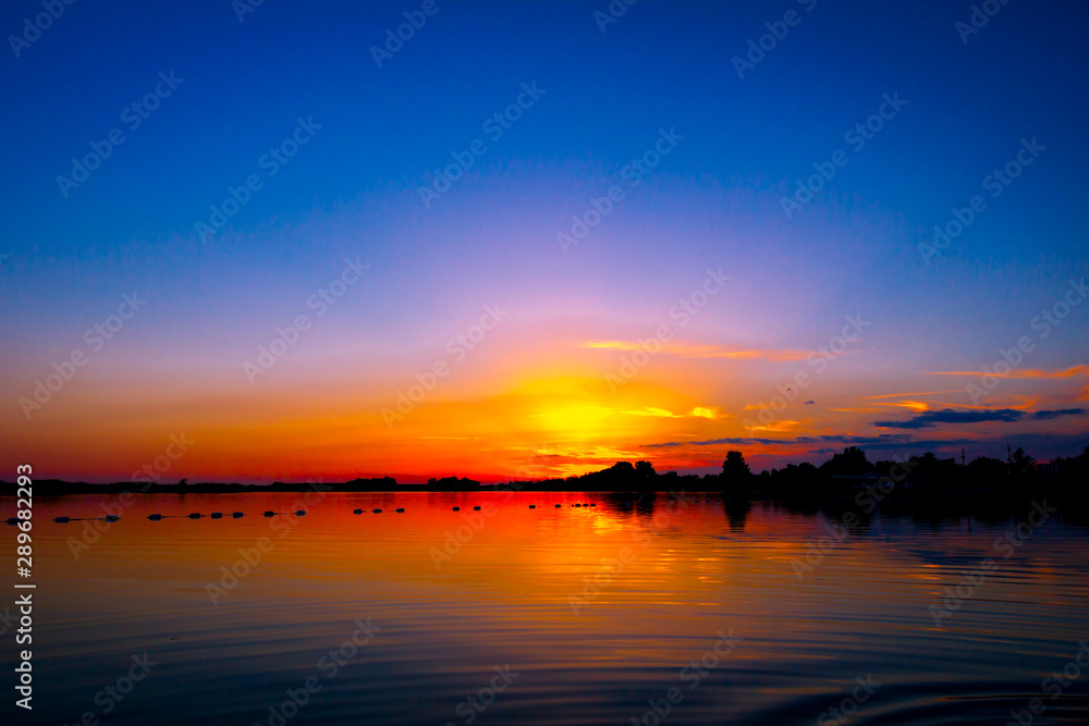 Colorful sky in sunset over the lake