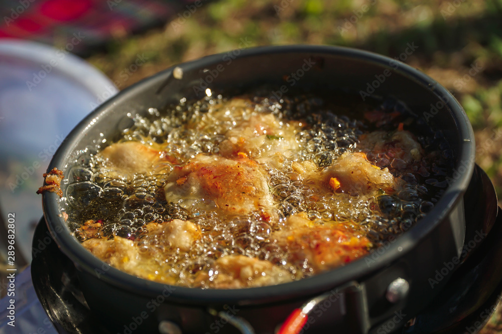 Perkedel jagung or bakwan jagung, corn fritters that is in fry in Portable stove. Indonesian cuisine. Perkedel jagung or bakwan jagung, corn fritters that is in fry in Portable stove. Indonesian cuisine.