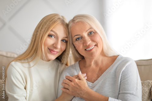 Portrait of beautiful mother and daughter at home