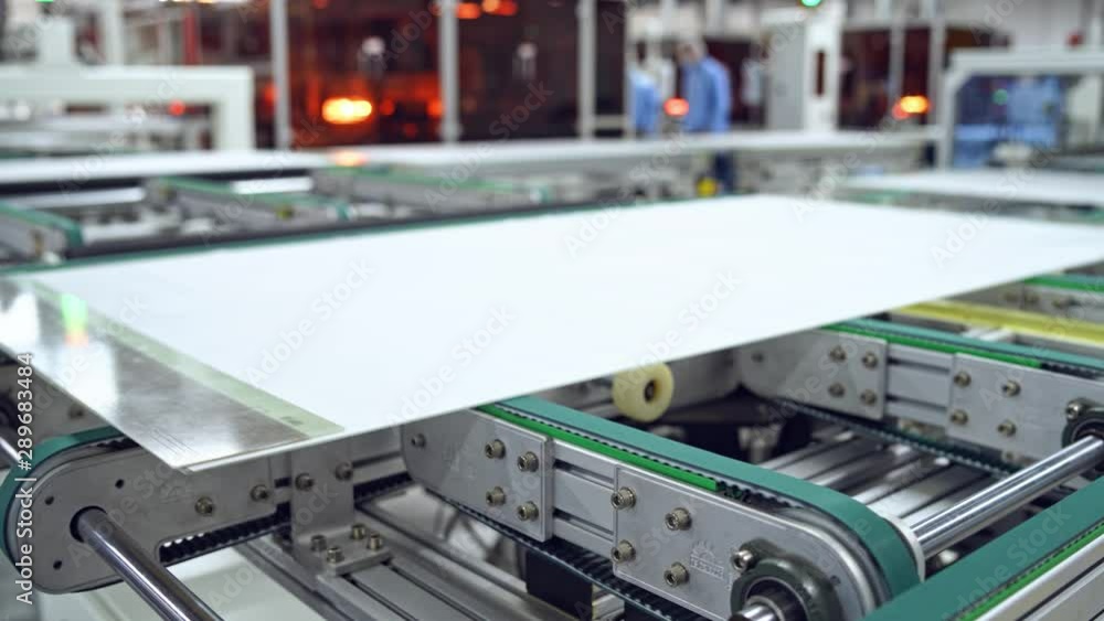 Process of making clean solar panels inside a modern factory. Automated machine for producing solar cells. Robotic equipment of contemporary plant.