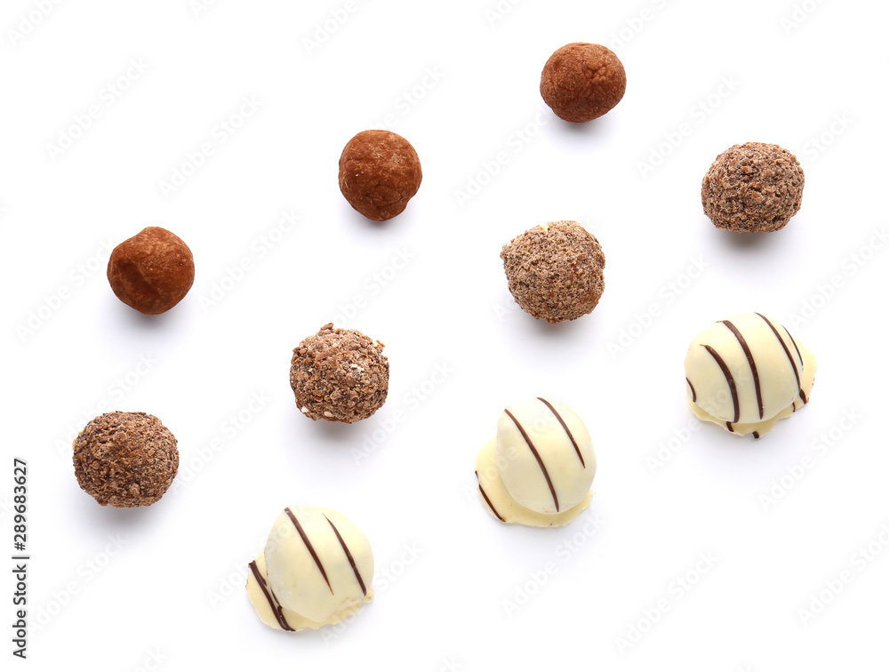 Tasty sweet truffles on white background