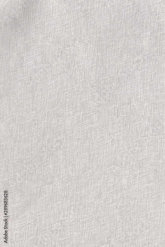 White patterned fabric background. Fabric lace close up. Seamless white canvas fabric texture wallpaper.