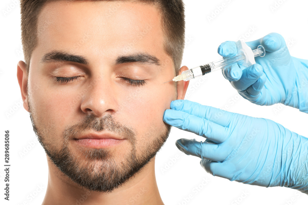 Handsome man receiving filler injection on white background Handsome man receiving filler injection on white background