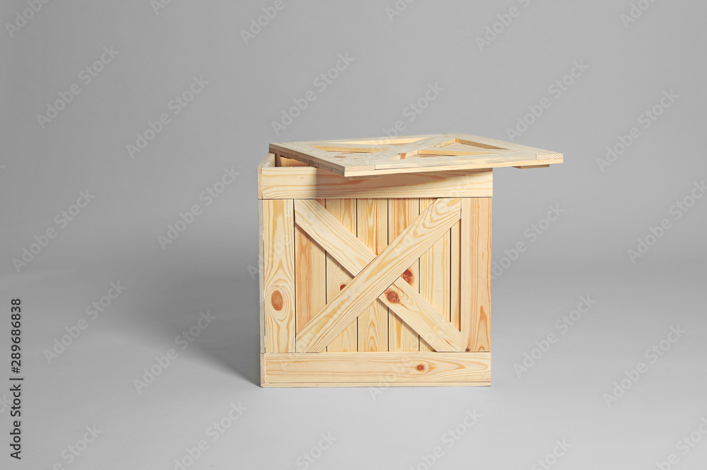One open wooden crate on grey background One open wooden crate on grey background