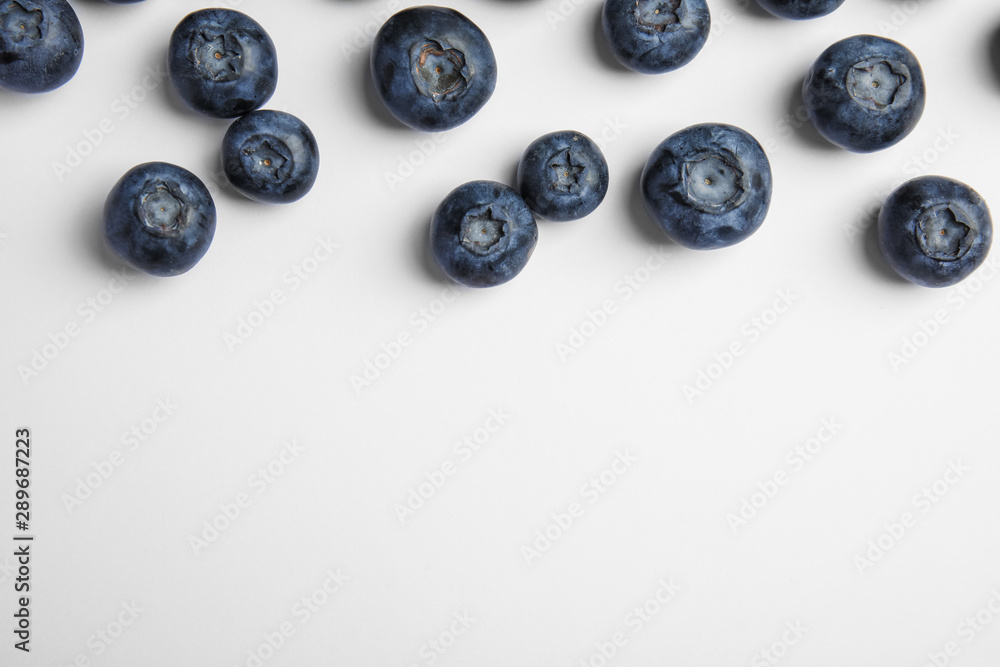 Tasty ripe blueberries on white background, flat lay Tasty ripe blueberries on white background, flat lay