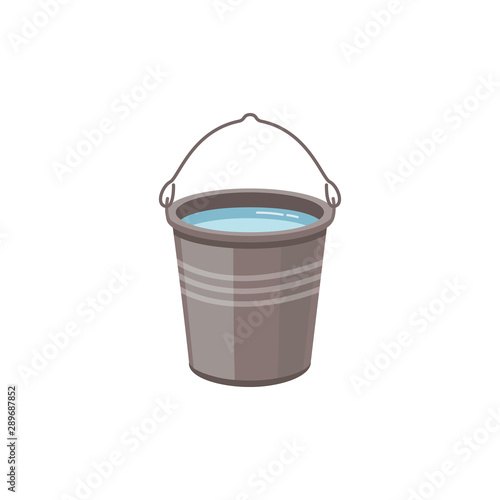A metal aluminum or steel bucket with water for washing a home or gardening.