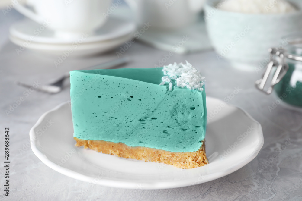 Piece of tasty spirulina cheesecake on grey table, closeup view Piece of tasty spirulina cheesecake on grey table, closeup view