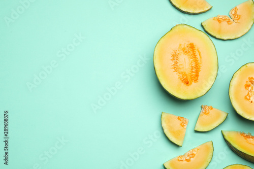 Flat lay composition with tasty melon on turquoise background, space for text