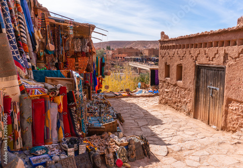 Streets in The fortified town of Ait ben Haddou near Ouarzazate on the edge of the sahara desert in Morocco. Atlas mountains. Street local ethnic market with goods and carpets photo