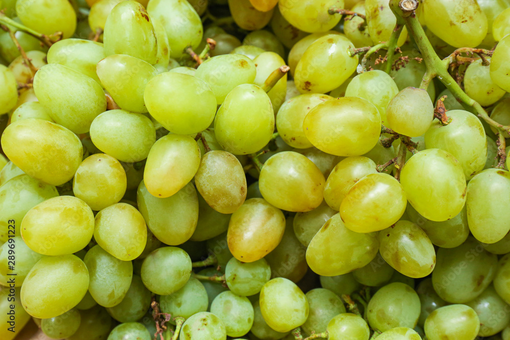 Fresh ripe juicy white grapes as background, closeup view Fresh ripe juicy white grapes as background, closeup view