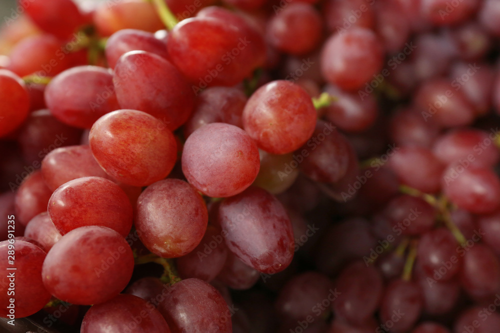 Fresh ripe juicy red grapes as background, closeup view Fresh ripe juicy red grapes as background, closeup view