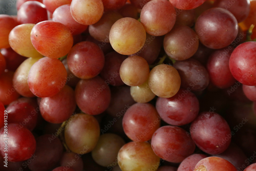 Fresh ripe juicy red grapes as background, closeup view Fresh ripe juicy red grapes as background, closeup view