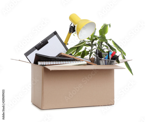 Cardboard box full of office stuff on white background