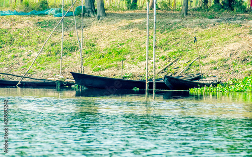 Bird watching rowing boats on the shore of wetland of Chupir Chor oxbow lake (Damodar and Ganges river with tropical lush of Gangetic plains) in Purbasthali Birdwatching place, West Bengal India. photo