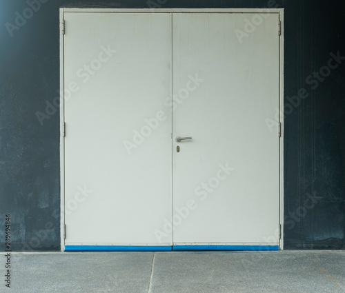 Wallpaper Mural White door with warehouse closeup and road cones Torontodigital.ca