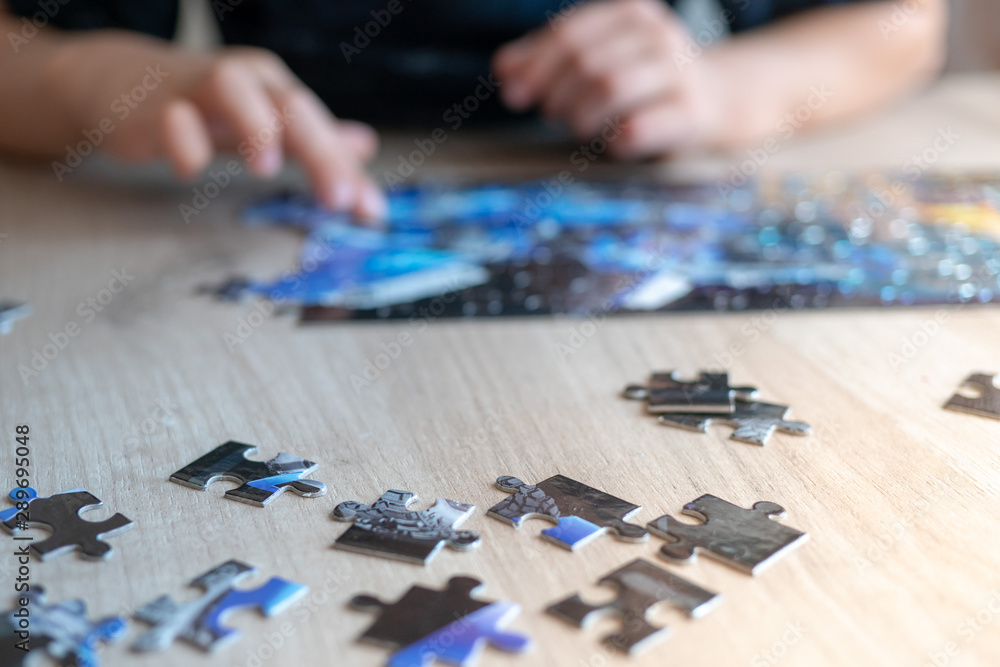 boy raises a small puzzle. childhood development boy raises a small puzzle. childhood development