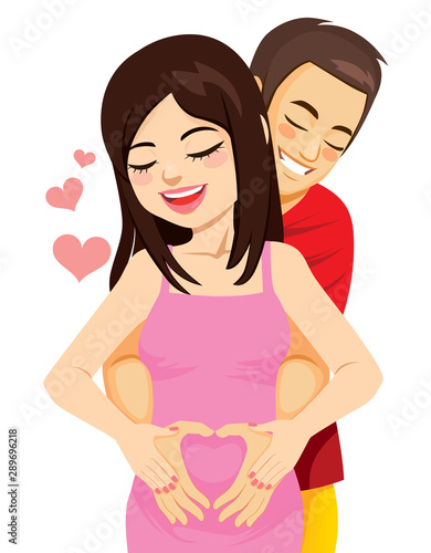 Happy parents couple making heart love symbol with hands on the belly of pregnant mother