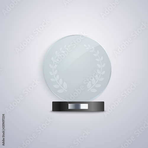 Realistic glass circle award mockup on black base with blank silver plaque.