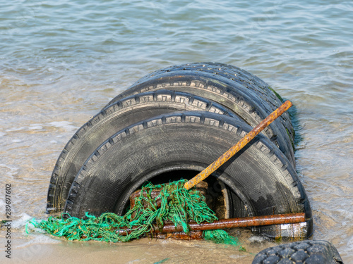 view of the sandy beach by the Baltic Sea. Seashore with old car tires and concrete, human waste, Curonian Spit, Russia