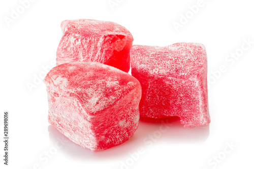 Turkish delight. Rose rahat locum, three pieces of sweet oriental delights in powered sugar. Close-up view.