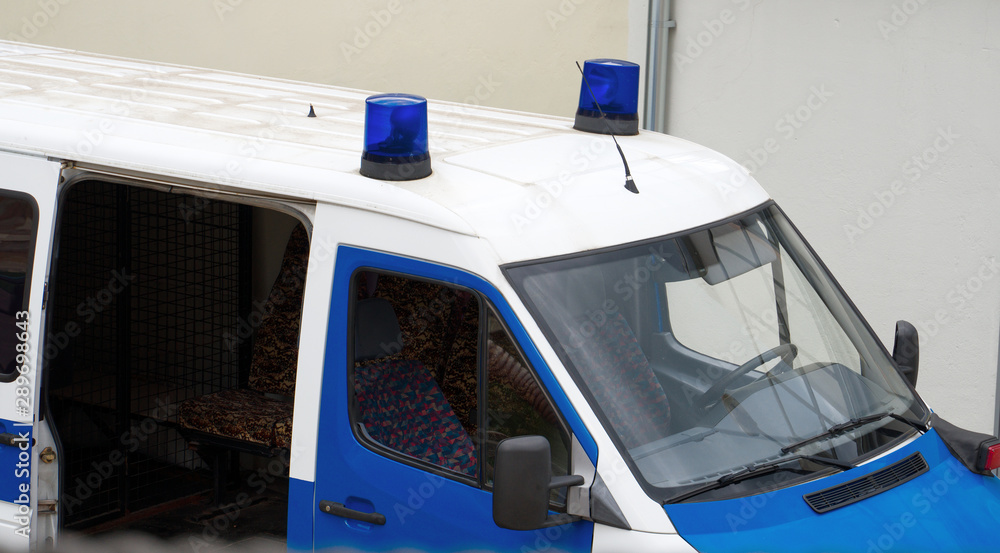 Police van with light bars on the street.