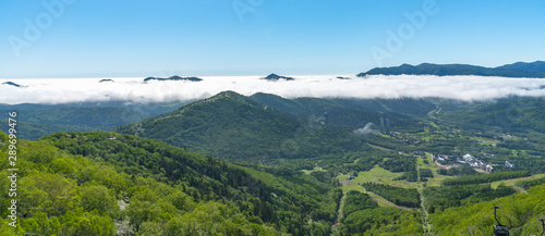 Panorama view from Unkai Terrace in summer time sunny day. Take the cable car at Tomamu Hoshino Resorts, going up to see the sea of clouds. Shimukappu village, Hokkaido, Japan photo