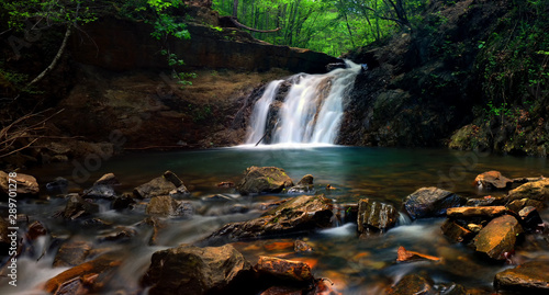 Creek flowing waterfall thru gorge and rocks