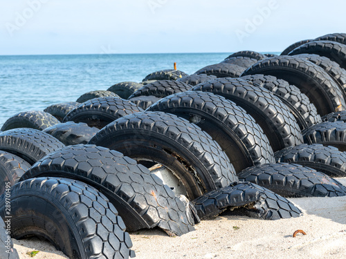 view of the sandy beach by the Baltic Sea. Seashore with old car tires and concrete, human waste, Curonian Spit, Russia