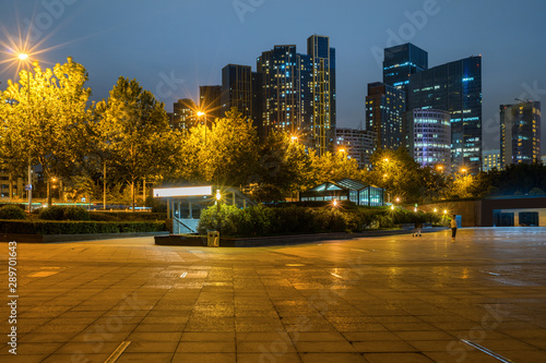 At night, modern city buildings and plazas are in the financial center of Qingdao, China.