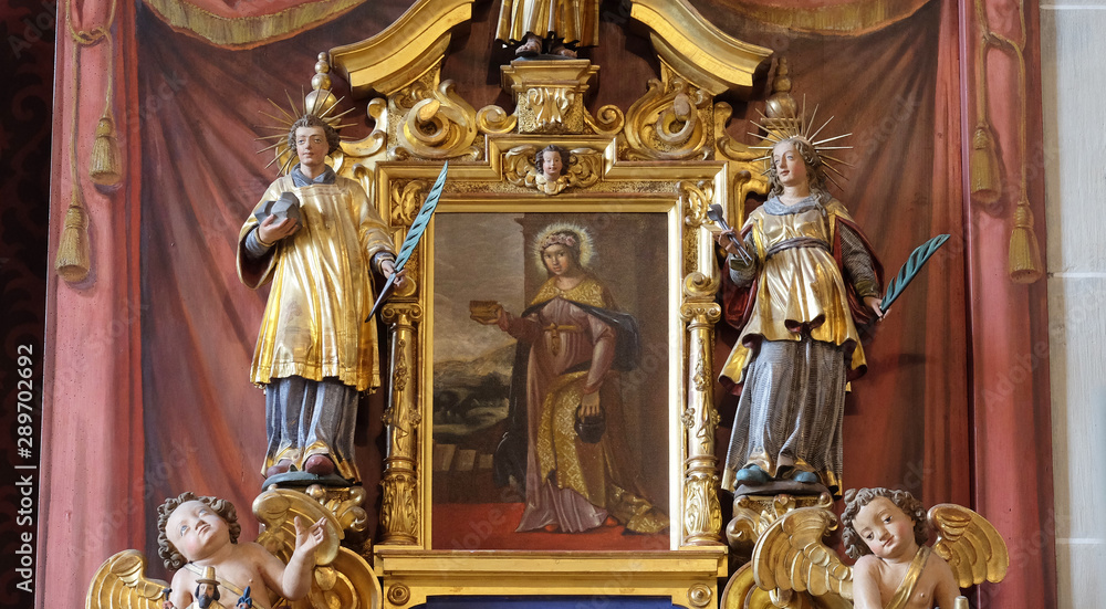 Saint Verena surrounded by the statues of Saints, altar of Saint Maurice in the church of St. Leodegar in Lucerne, Switzerland