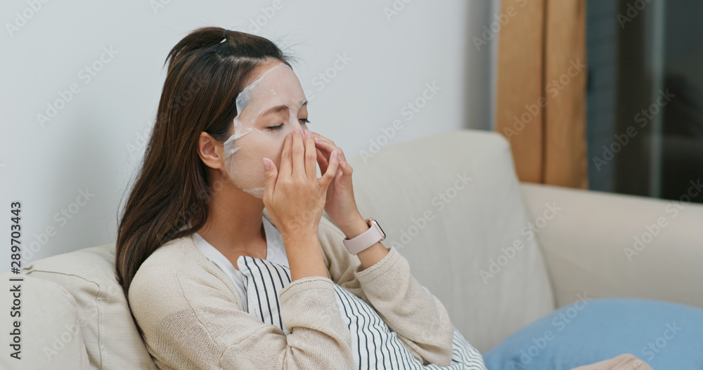 Woman apply facial mask on face at home Woman apply facial mask on face at home