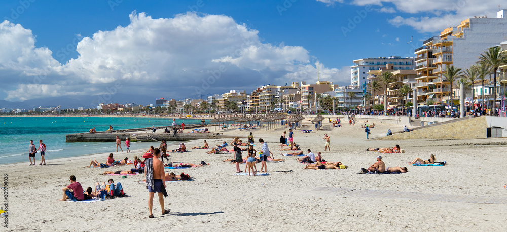 People sunbathing on the beach of El Arenal resort town,  Majorca, Baleares, Spain