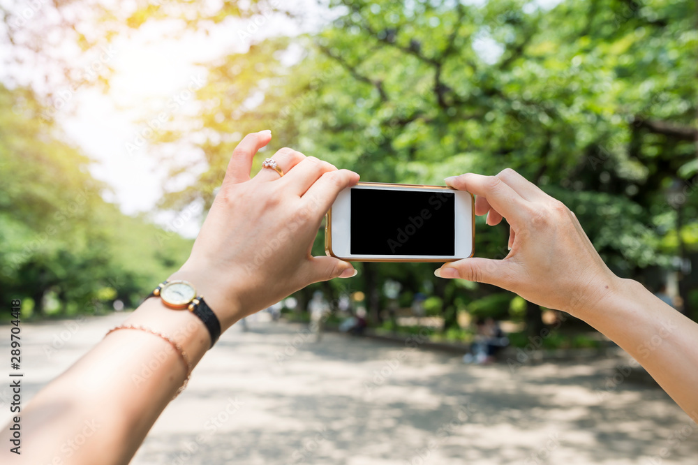 Tourist hold blank smartphone for taking mobile photo Tourist hold blank smartphone for taking mobile photo