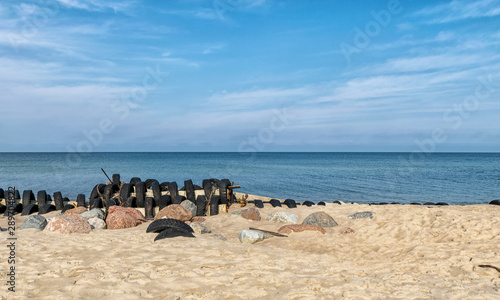 view of the sandy beach by the Baltic Sea. Seashore with old car tires and concrete, human waste, Curonian Spit, Russia