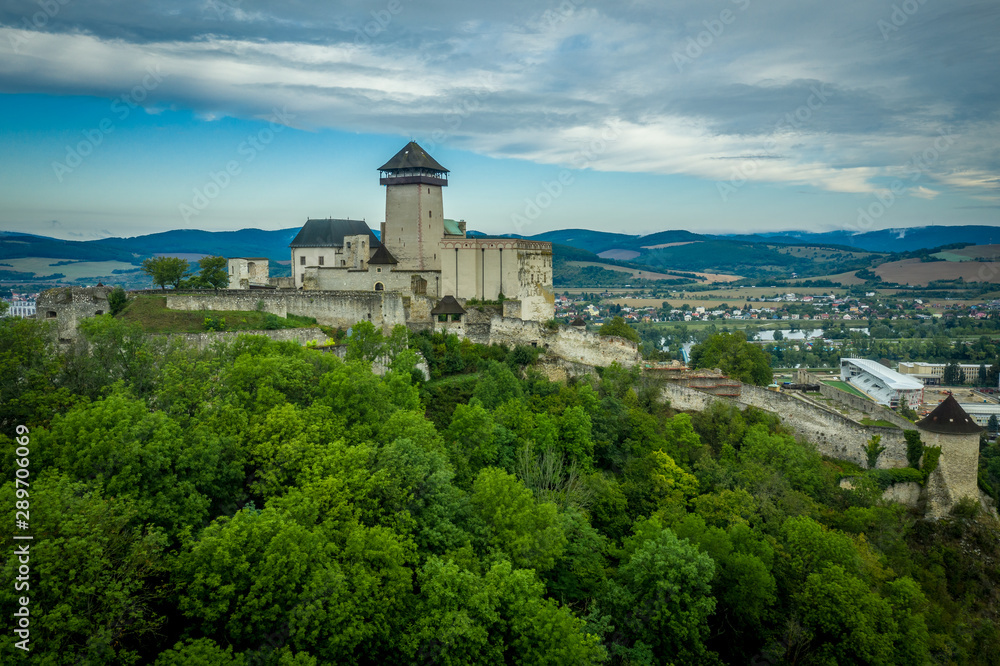 Aerial panorama view of medieval newly restored Trencin castle over the Vah river in Slovakia  with dramatic sky