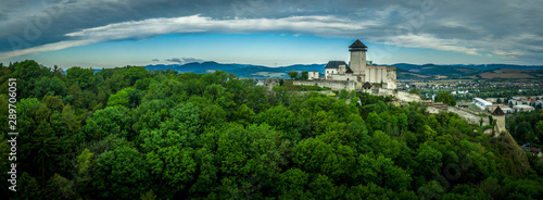 Aerial panorama view of medieval newly restored Trencin castle over the Vah river in Slovakia  with dramatic sky photo