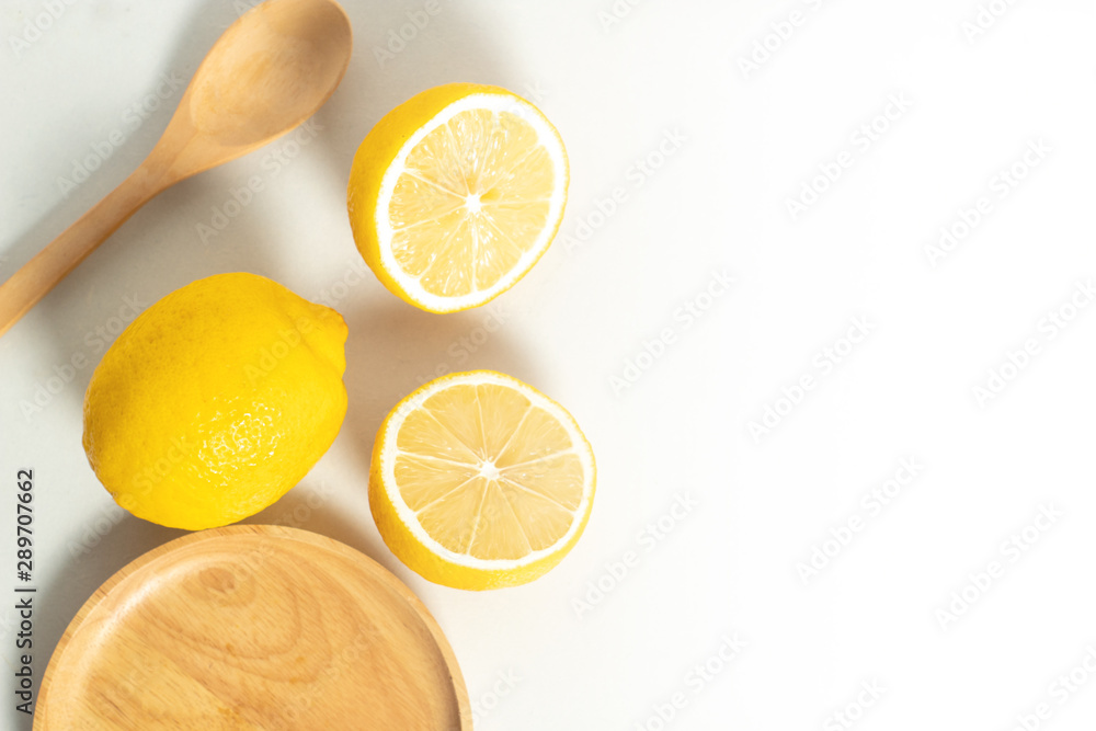 tropical fruit fresh natural lemon with wood cup dish and spoon fork, kitchen table isolated background, organic food and nutrition vitamin citrus, diet and healthy tropical fruit fresh natural lemon with wood cup dish and spoon fork, kitchen table isolated background, organic food and nutrition vitamin citrus, diet and healthy