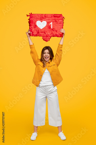 Cheerful woman showing banner with like photo