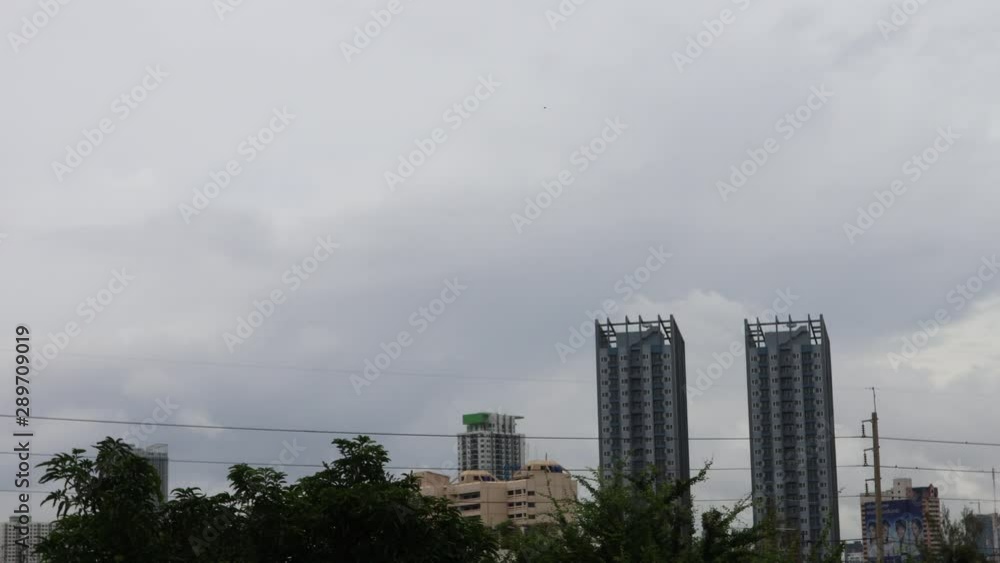 Cloudscape with clouds in motion time lapse, cityscape, silhouette skyscraper, static shot Cloudscape with clouds in motion time lapse, cityscape, silhouette skyscraper, static shot