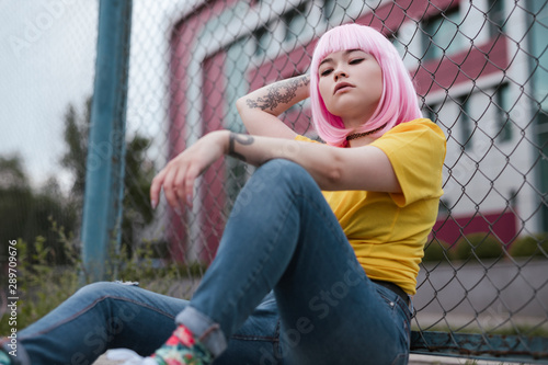 Canvas-taulu Confident Asian teenager leaning on fence